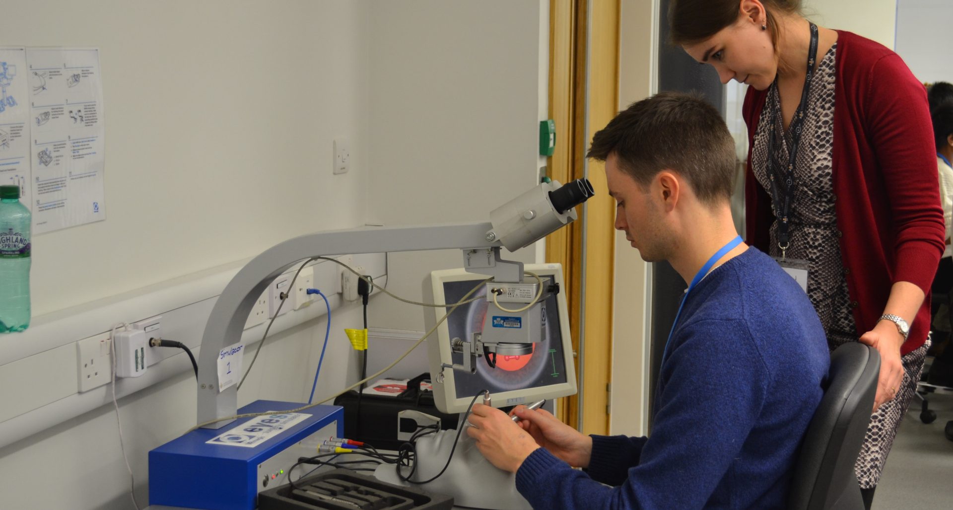 A trainee ophthalmologist being supervised on an eyesi surgical simulator