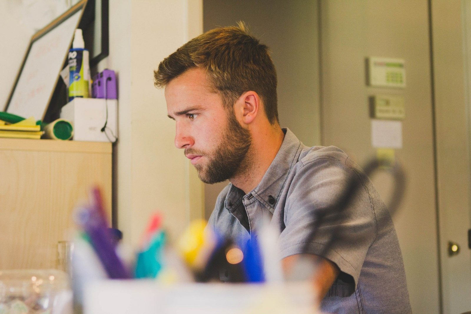 A man sitting at his desk working on a computer