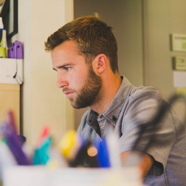 A man sitting at his desk working on a computer